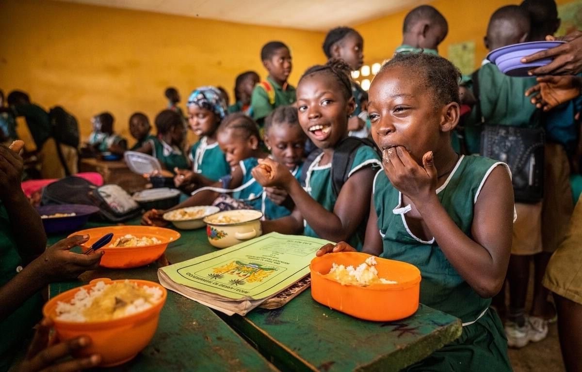 Ugandan children smiling together outdoors in a village