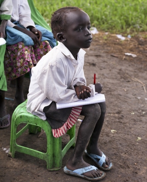 Portrait of Amina, a 16-year-old student, smiling