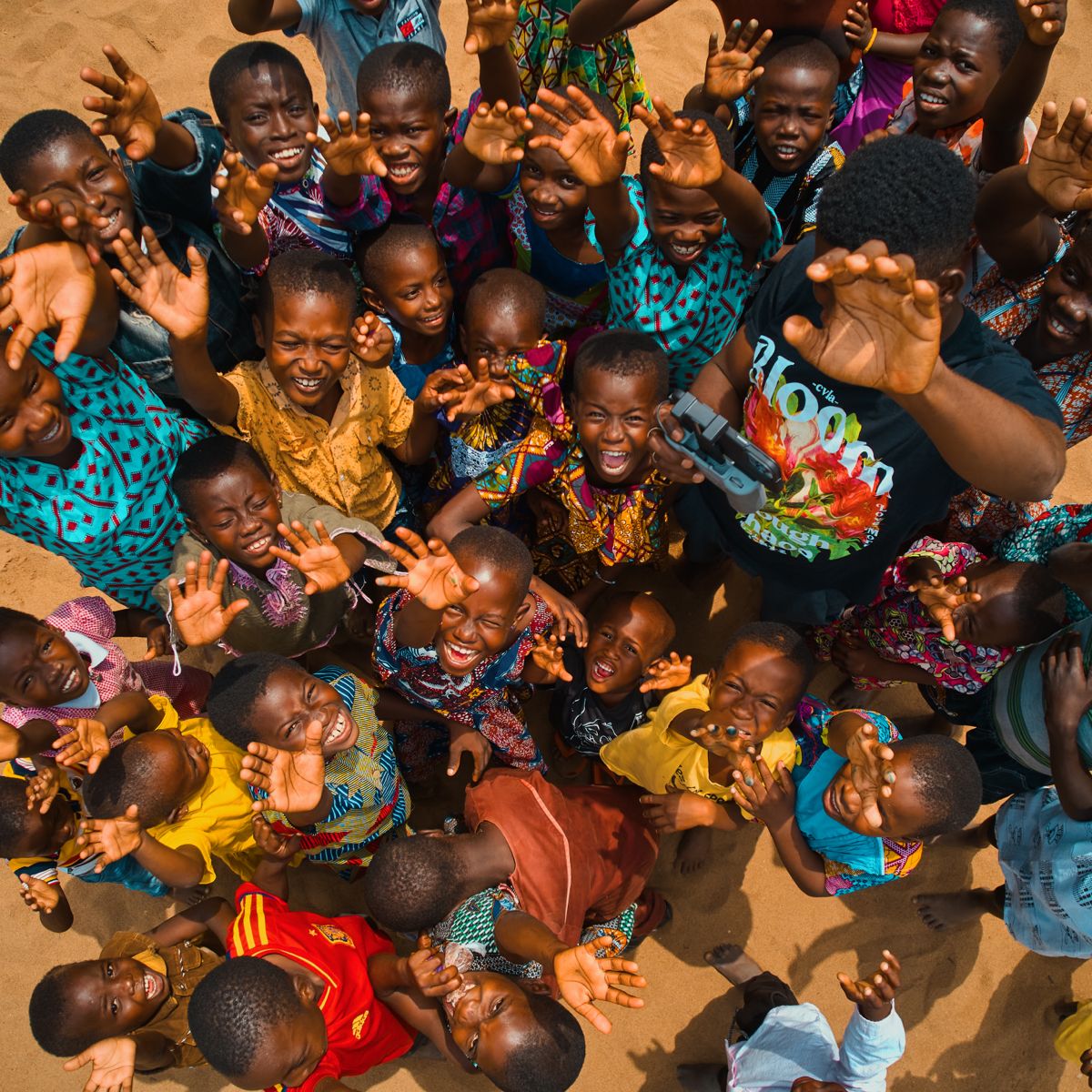 Children running joyfully together along a dirt path